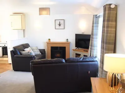 a living room with a couch and a fireplace at The Granary Couples & Families Retreat Near St Ives, Pet-Free in St Ives