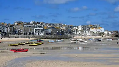 a beach with boats on the sand and buildings at The Granary Couples & Families Retreat Near St Ives, Pet-Free in St Ives