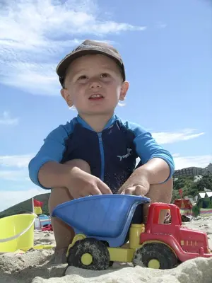 a young boy playing with a toy truck in the sand at The Granary Couples & Families Retreat Near St Ives, Pet-Free in St Ives