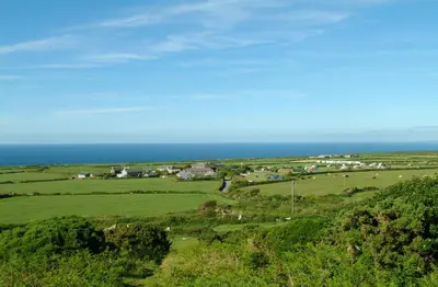 an aerial view of a farm with the ocean in the background at The Granary Couples & Families Retreat Near St Ives, Pet-Free in St Ives