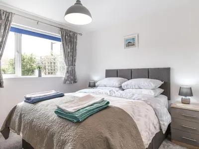 a bedroom with a bed with two towels on it at Orchard View in St Austell