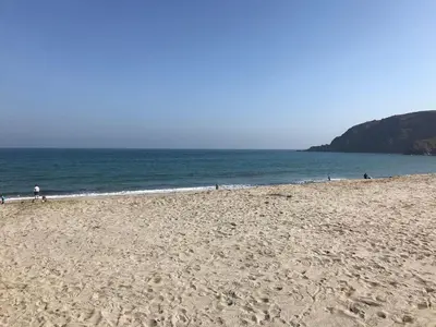 a group of people on a beach near the ocean at Orchard View in St Austell