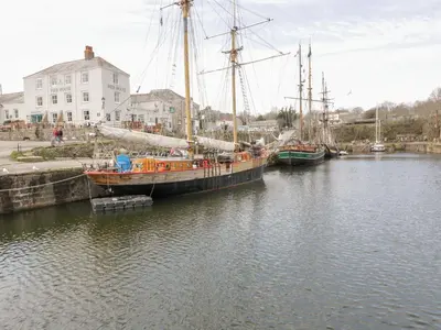 two boats are docked in a body of water at Orchard View in St Austell