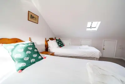 a bedroom with two beds and a window at Hardys in Padstow