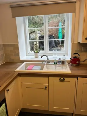 a kitchen with a sink and a window at Seahorse Cottage in Boscastle