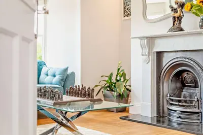 a living room with a glass table and a fireplace at 5 Bed in Porthleven oc-t24809 in Porthleven
