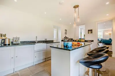 a kitchen with white cabinets and black counter tops at 5 Bed in Porthleven oc-t24809 in Porthleven