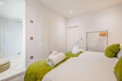 a bedroom with a large white bed with towels on it at 5 Bed in Porthleven oc-t24809 in Porthleven