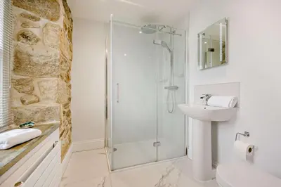 a white bathroom with a shower and a sink at 5 Bed in Porthleven oc-t24809 in Porthleven