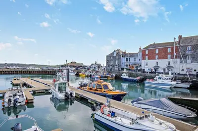 a group of boats are docked in a harbor at 2 Bed in Padstow oc-28108 in Padstow