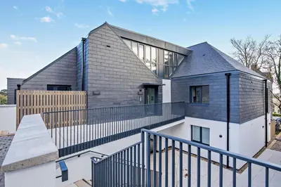 a house with a gray roof and a fence at 2 Bed in Padstow oc-28108 in Padstow