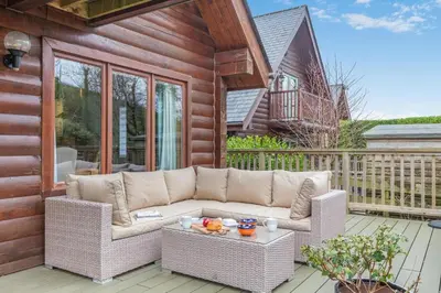 a patio with a couch and a table on a deck at 3 Bed in Wadebridge oc-p34722 in Little Petherick