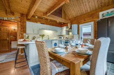a kitchen with a wooden table and chairs at 3 Bed in Wadebridge oc-p34722 in Little Petherick