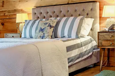 a bedroom with a bed with blue and white pillows at 3 Bed in Wadebridge oc-p34722 in Little Petherick