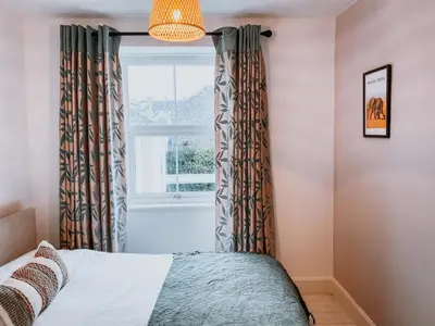 a bedroom with a bed and a window at Twiga Cottage - Quiet 2 bed - Heart of town - Walk to beaches in Newquay