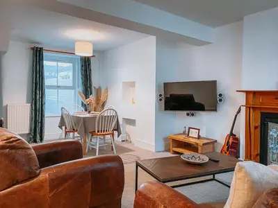 a living room with a couch and a table at Twiga Cottage - Quiet 2 bed - Heart of town - Walk to beaches in Newquay