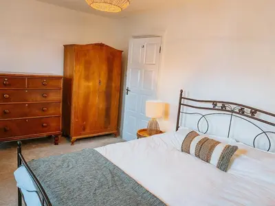 a bedroom with a white bed and a dresser and a drawer at Twiga Cottage - Quiet 2 bed - Heart of town - Walk to beaches in Newquay
