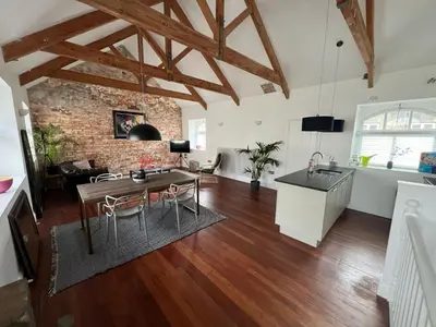 a kitchen and a living room with a table at 8, St Marys ,Central Truro Apartment, Long Stay Ready, 2 Bed 2 Bath in Truro