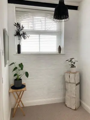 a room with a window and a table with plants at 8, St Marys ,Central Truro Apartment, Long Stay Ready, 2 Bed 2 Bath in Truro