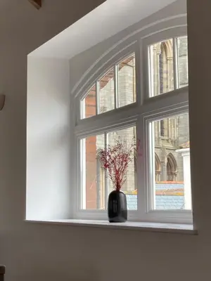 a window with a vase with flowers in it at 8, St Marys ,Central Truro Apartment, Long Stay Ready, 2 Bed 2 Bath in Truro