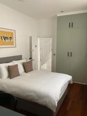 a bedroom with a large white bed with two pillows at 8, St Marys ,Central Truro Apartment, Long Stay Ready, 2 Bed 2 Bath in Truro