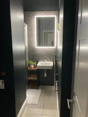 a bathroom with a sink and a mirror at 8, St Marys ,Central Truro Apartment, Long Stay Ready, 2 Bed 2 Bath in Truro