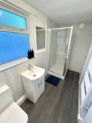 a bathroom with a sink and a shower and a toilet at The Old Corner Shop - Wellington Terrace in Falmouth