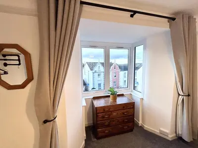 a room with a refrigerator and a window at The Old Corner Shop - Wellington Terrace in Falmouth