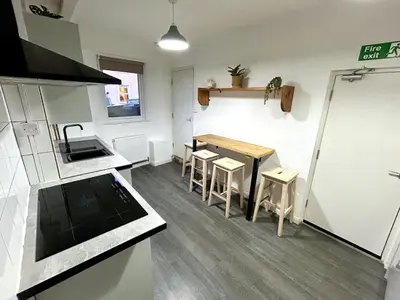 a small kitchen with a table and chairs in it at The Old Corner Shop - Wellington Terrace in Falmouth