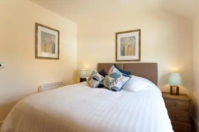 a bedroom with a large white bed with blue pillows at Holly in Kea