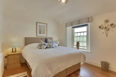 a bedroom with a large bed and a window at Holly in Kea