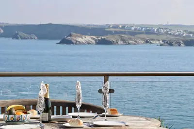 a table with food and a view of the water at Sea View House in Newquay
