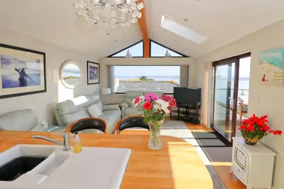 a living room with a vase of flowers on a table at Sea View House in Newquay