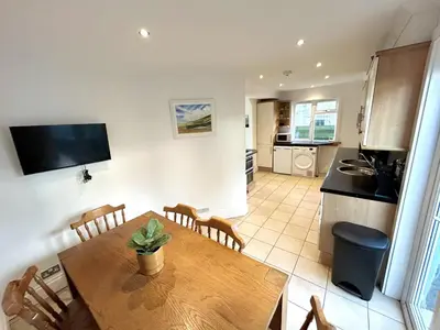 a kitchen and dining room with a table and chairs at The Blue House - Godolphin - Large Spacious Home in Falmouth