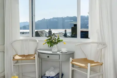 two chairs and a table in front of a window at Sealight Cottage in St Ives