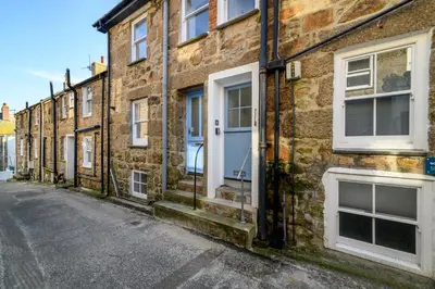 a row of brick houses on a street at Sealight Cottage in St Ives
