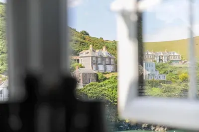 a view of a town from a window with houses at Rose Hill Cottage in Port Isaac