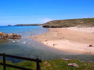 a group of people on a beach near the water at Cornwall Log Burner no cleaning fee in Camborne