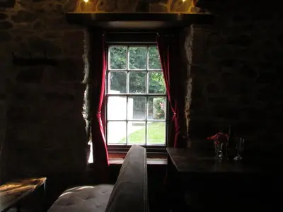a window in a room with a couch and a table at Cornwall Log Burner no cleaning fee in Camborne