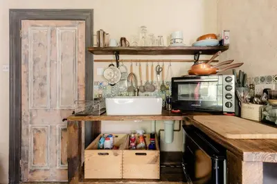 a kitchen with a counter with a microwave and a sink at Cornwall Log Burner no cleaning fee in Camborne