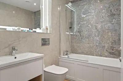 a bathroom with a toilet and a sink and a shower at Groundfloor Apartment Opposite Beach with Parking in Newquay