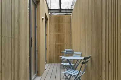 a patio with tables and chairs in a building at Groundfloor Apartment Opposite Beach with Parking in Newquay