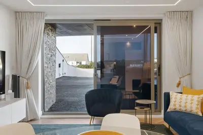 a living room with a couch and a chair at Modern Groundfloor Apartment with Private Parking in Newquay