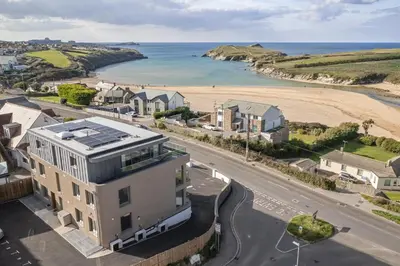 an aerial view of a house next to a beach at Modern Apartment with Balcony Sea Views & Parking in Newquay