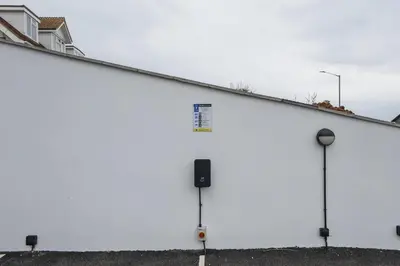 a large white building with a sign on the side at Modern Apartment Opposite Beach Parking & Balcony in Newquay
