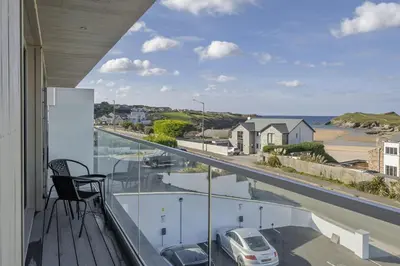 a balcony with a view of a car on a street at Luxurious Apartment Balcony & Sea Views Parking in Newquay