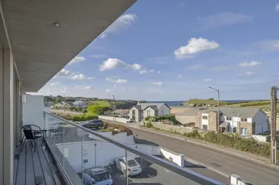 a balcony with a view of a street and a road at Luxurious Apartment Balcony & Sea Views Parking in Newquay