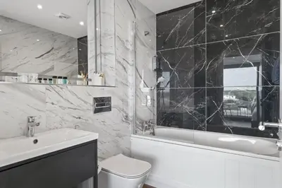 a bathroom with a tub and a toilet and a sink at Luxurious Apartment Balcony & Sea Views Parking in Newquay