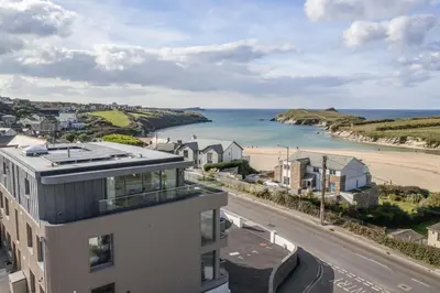 a building with a view of the ocean and a beach at Luxurious Apartment Balcony & Sea Views Parking in Newquay