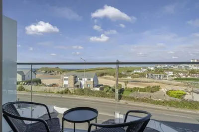 a balcony with chairs and a view of the ocean at Luxurious Apartment Balcony & Sea Views Parking in Newquay